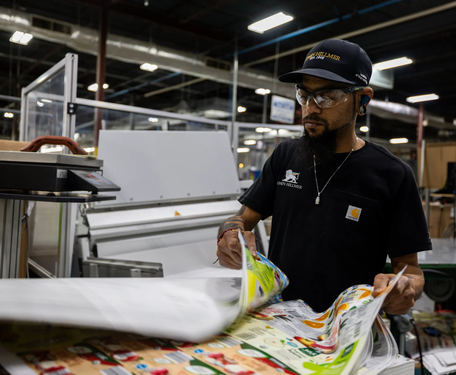 A QC employee at Epsen Hillmer verifies color management best practices for consistent label printing