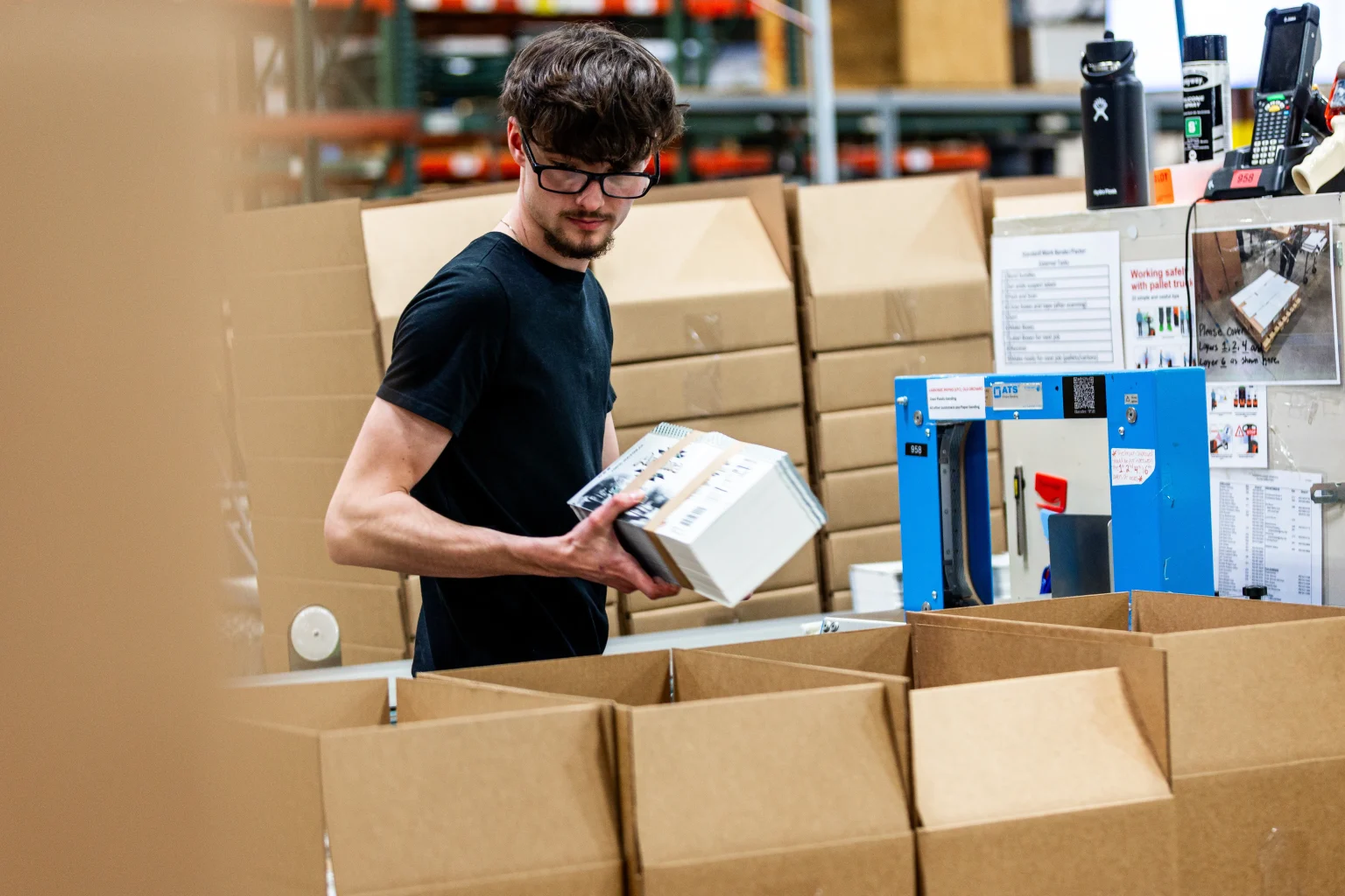 An Epsen Hillmer employee packs beverage labels for shipment