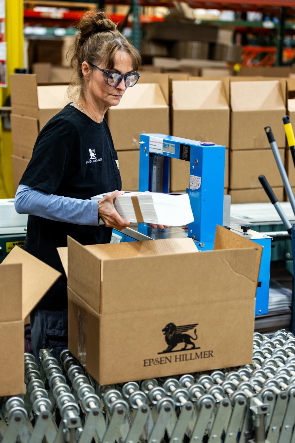 An Epsen Hillmer employee packs beverage labels for shipment