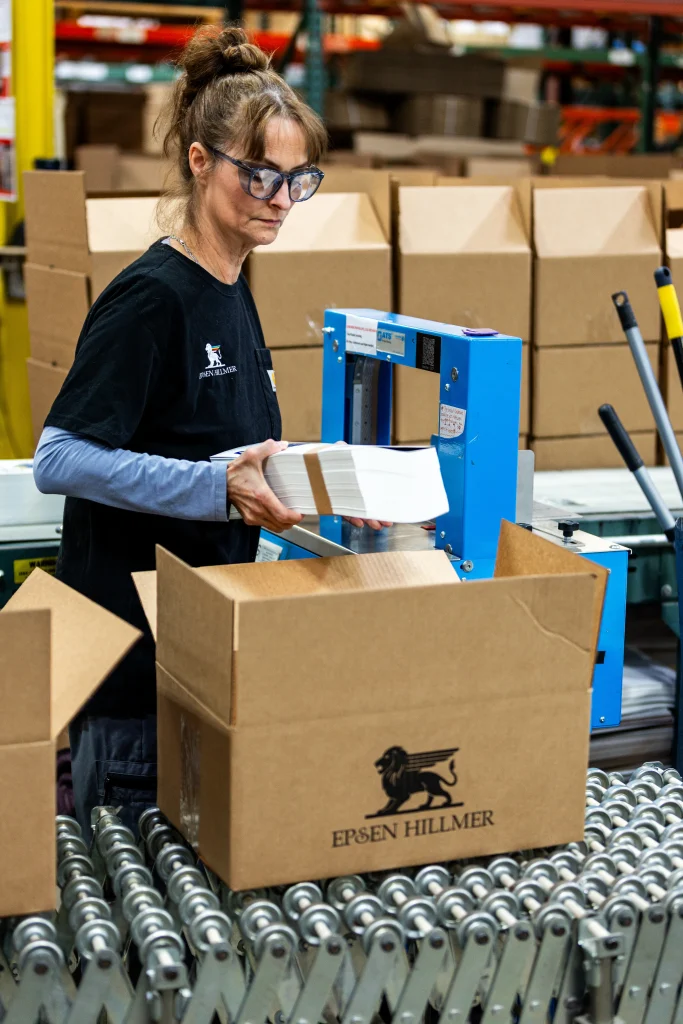An Epsen Hillmer employee packs beverage labels for shipment
